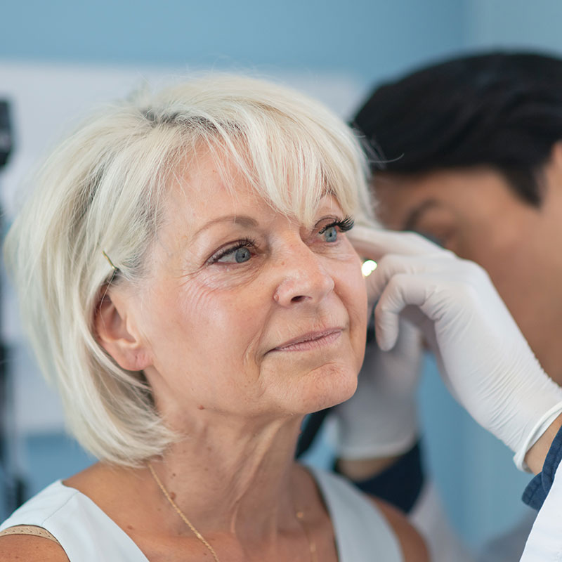 Doctor examining a patient's ear for a bone-anchored hearing aid