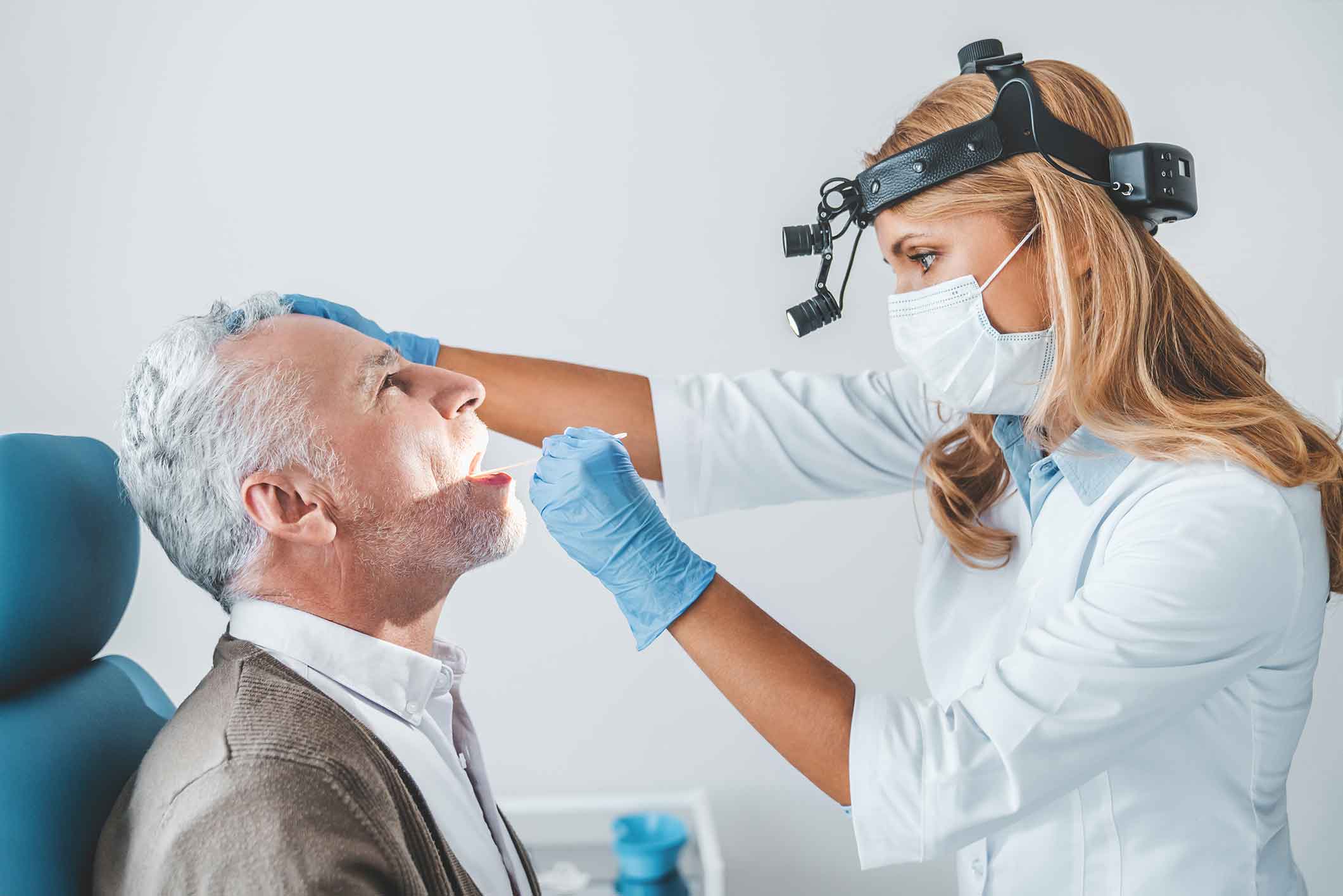 Doctor examining a patient's mouth