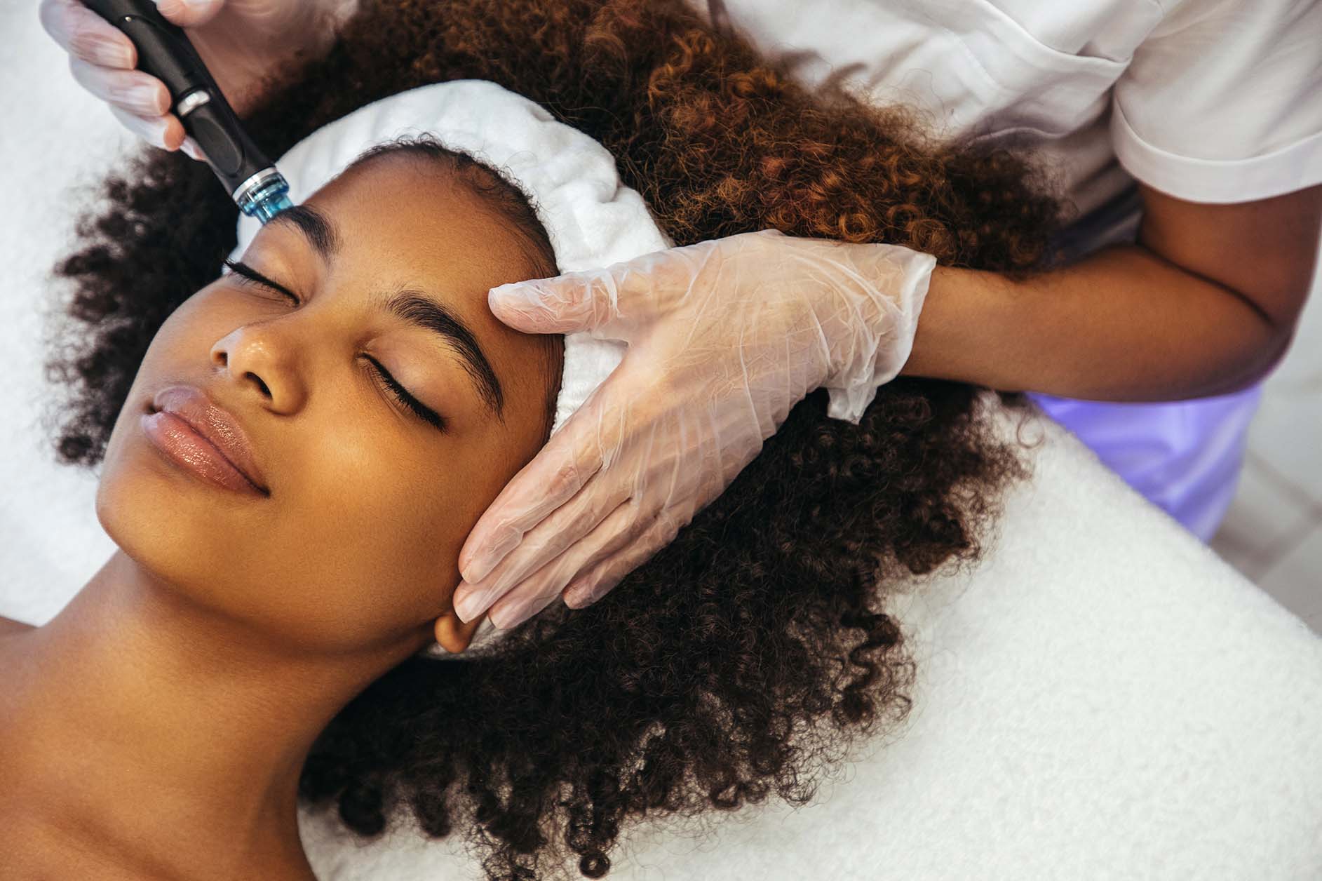 woman receiving facial cosmetic treatment