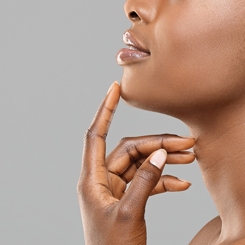 closeup photo of woman touching her chin